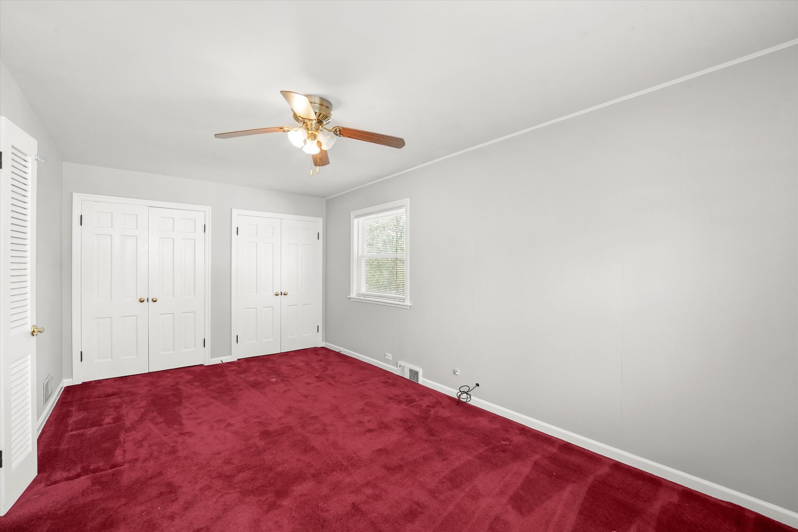 255 Irving Boulevard Chicago Heights, IL 60411 - Photo 11 of 42 a bedroom with a bed and a chandelier fan