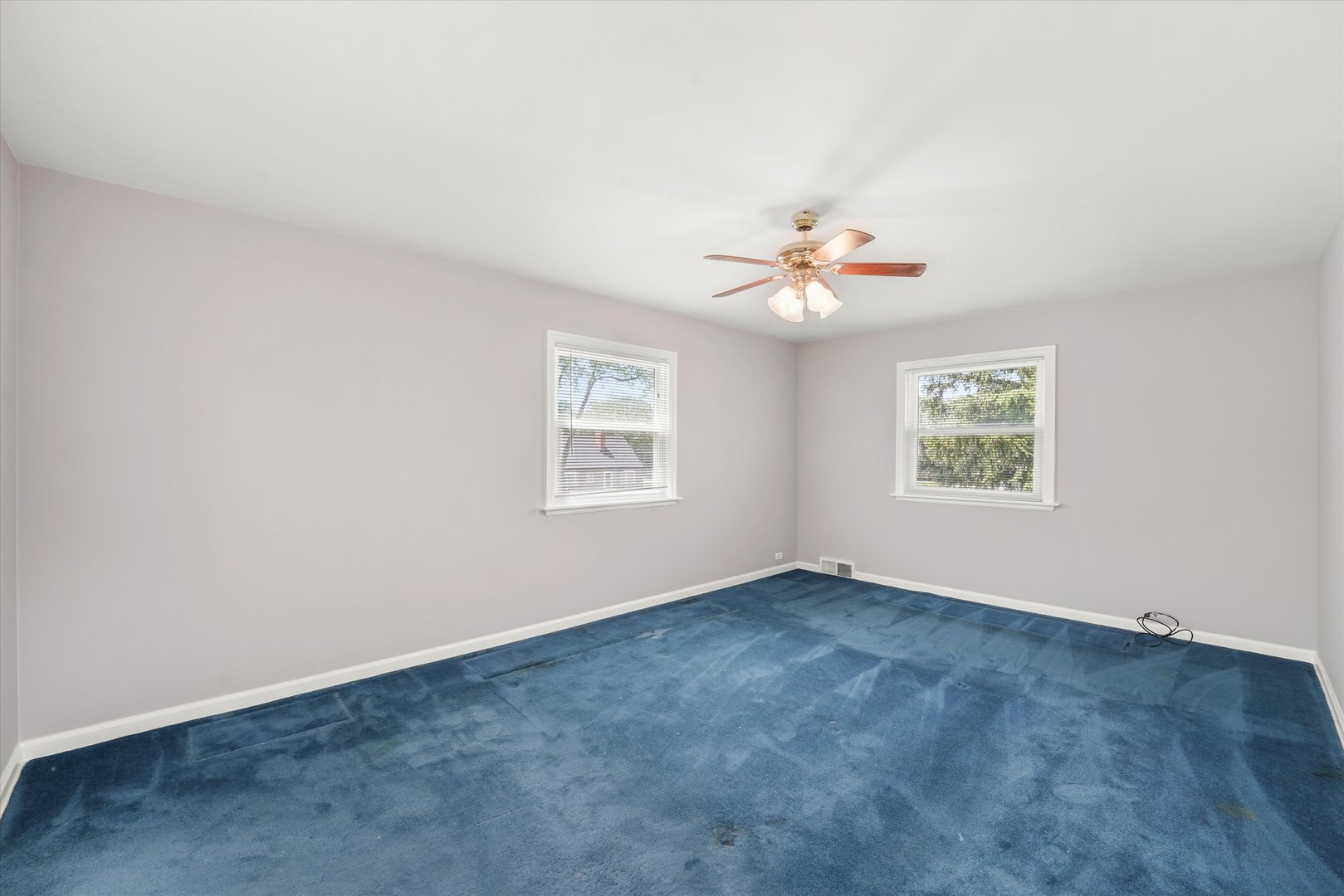 255 Irving Boulevard Chicago Heights, IL 60411 - Photo 12 of 42 an empty room with windows and chandelier fan