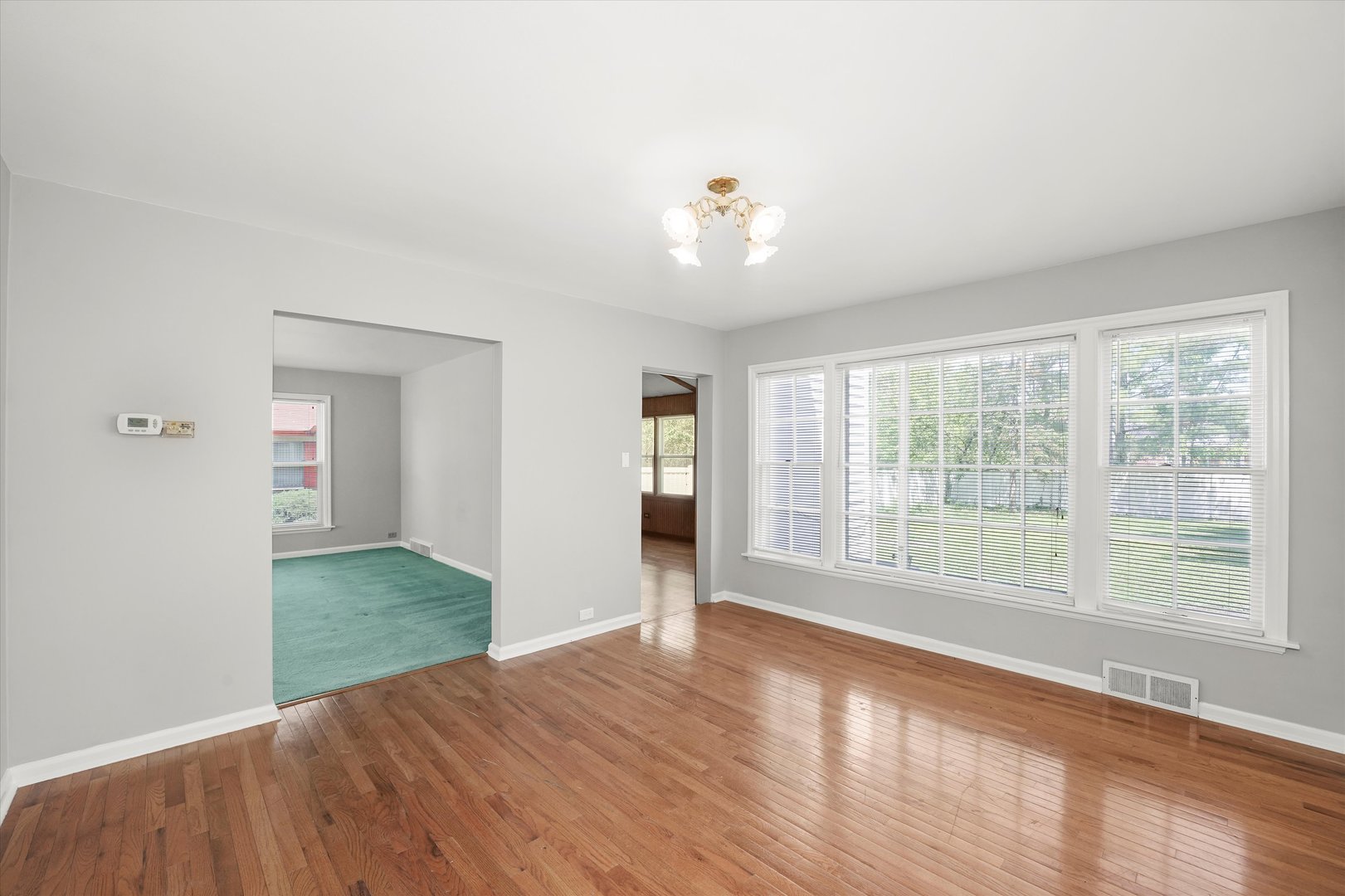 255 Irving Boulevard Chicago Heights, IL 60411 - Photo 15 of 42 a view of an empty room with wooden floor and a window