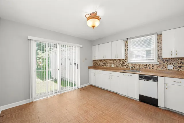 a kitchen with granite countertop white cabinets and white appliances