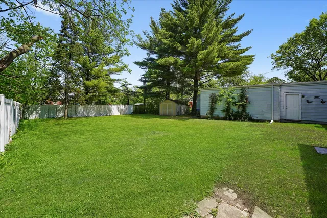 a front view of house with yard and trees