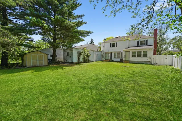 a view of a house with backyard and garden