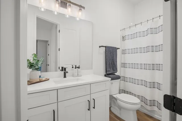 a kitchen with stainless steel appliances granite countertop a stove and a wooden floors