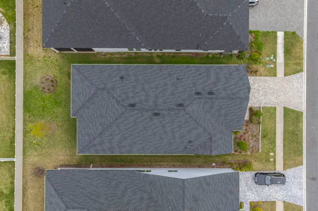 a view of a house with backyard and porch
