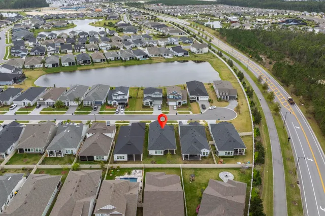 an aerial view of a house with a ocean view