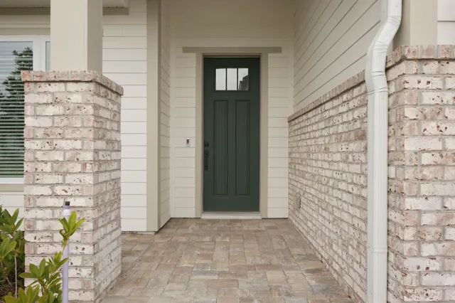 a view of front door of house with potted plant