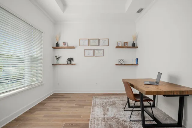a view of a dining room with furniture and wooden floor