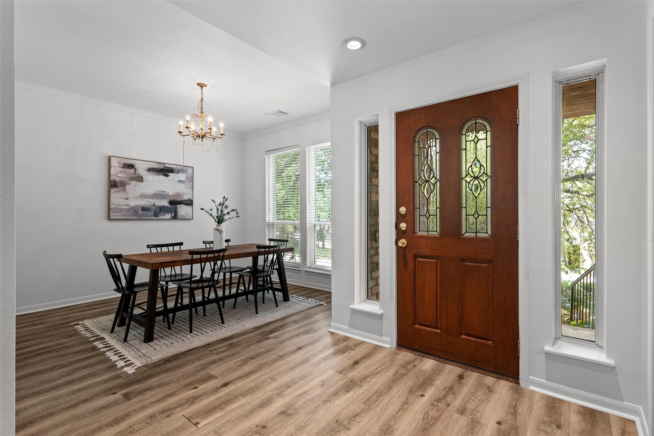7000 Colberg Court Austin, TX 78749 - Photo 4 of 40 A graceful chandelier illuminates the formal dining area and richly toned wood flooring.