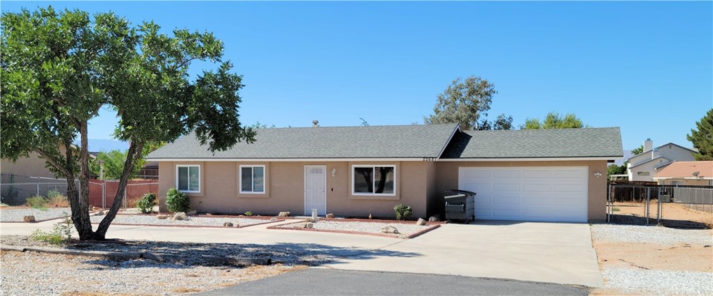 22687 S Road Apple Valley, CA 92307 - Photo 1 of 1 a front view of a house with garden