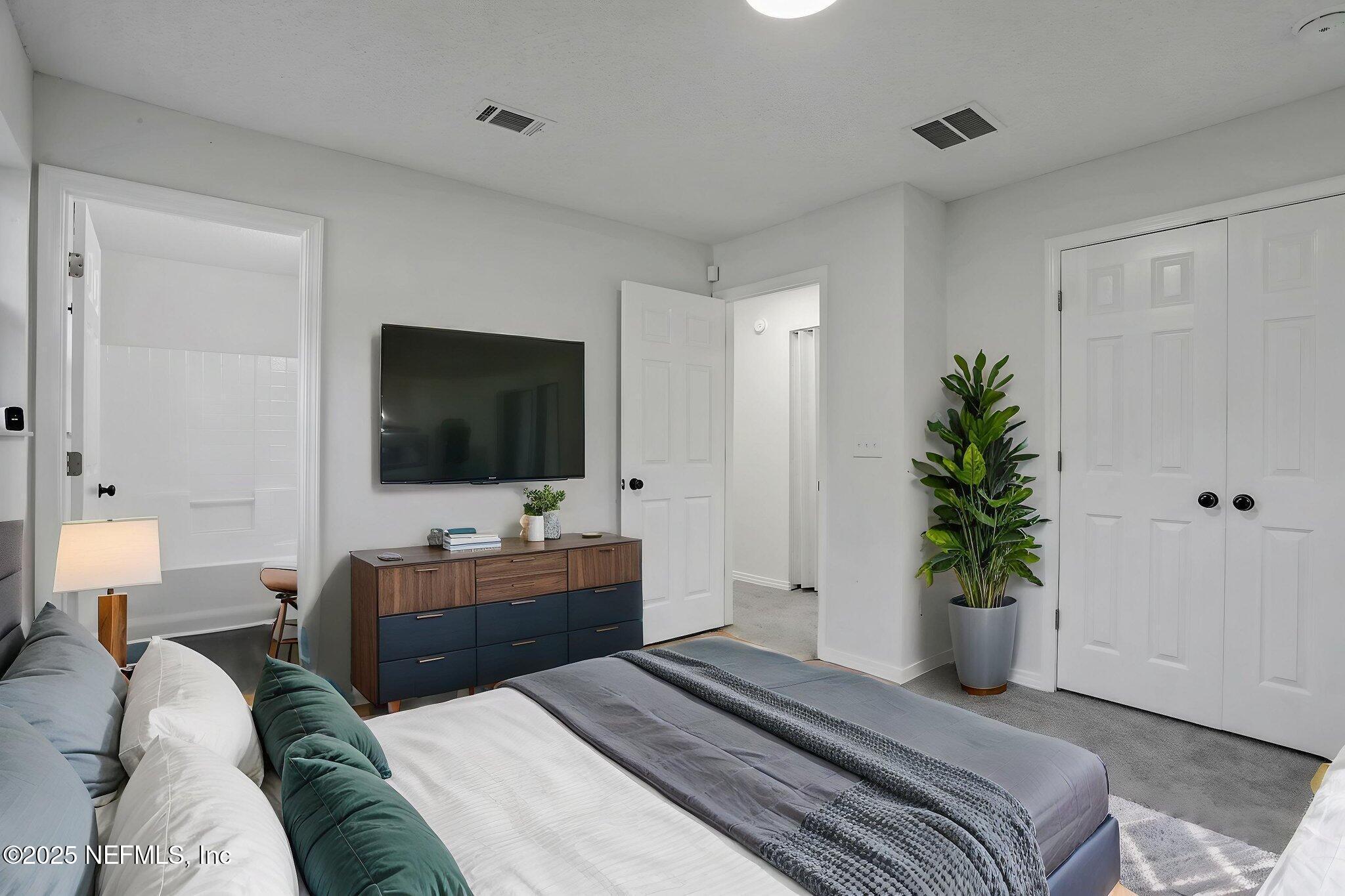 2122 Brooklyn Road Jacksonville, FL 32209 - Photo 11 of 19 a bedroom with a bed and a flat screen tv
