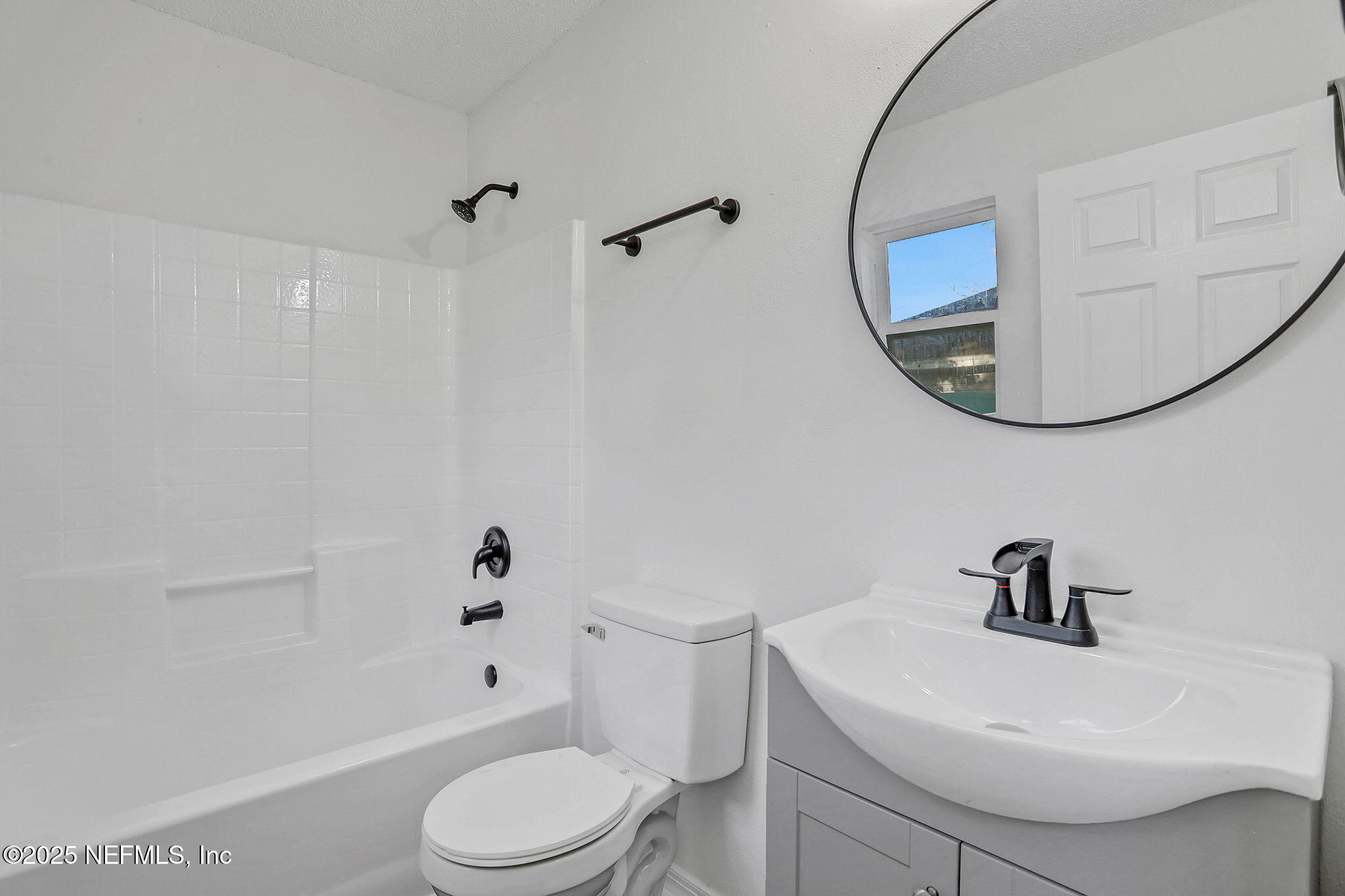 2122 Brooklyn Road Jacksonville, FL 32209 - Photo 12 of 19 a white toilet sitting next to a bathroom sink and vanity