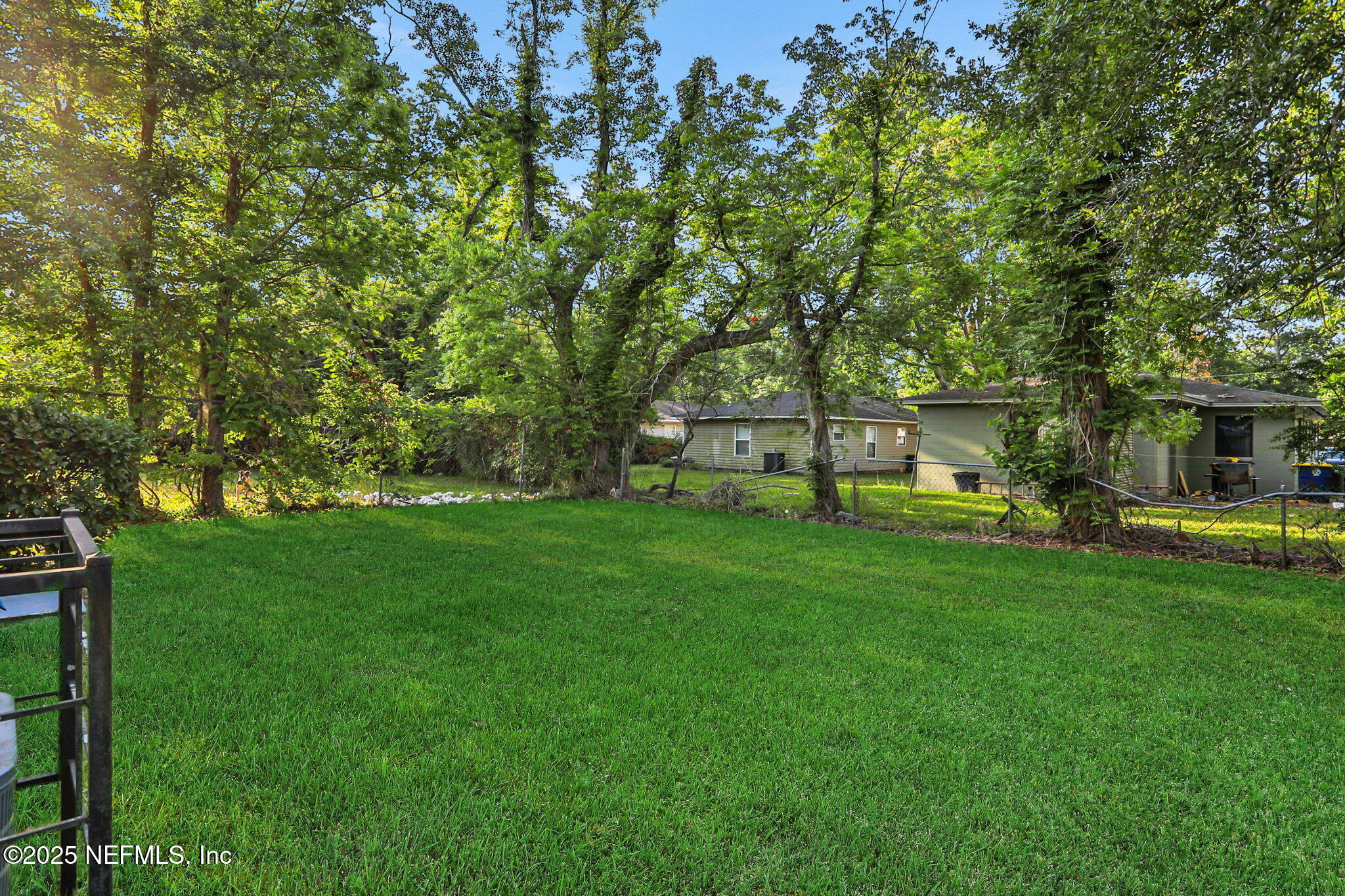 2122 Brooklyn Road Jacksonville, FL 32209 - Photo 2 of 19 a view of a backyard with table and chairs and potted plants and large trees