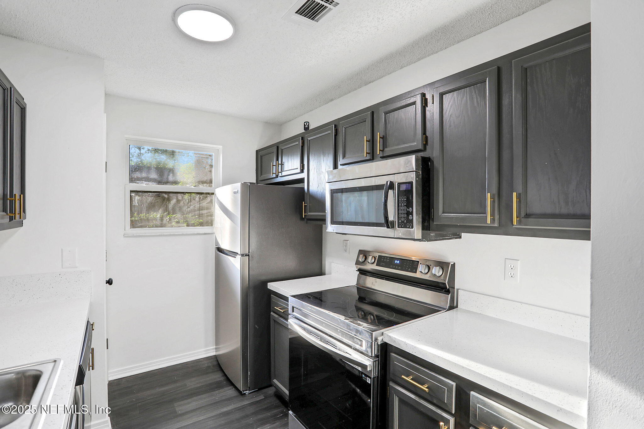 2122 Brooklyn Road Jacksonville, FL 32209 - Photo 4 of 19 a kitchen with a refrigerator stove and wooden cabinets