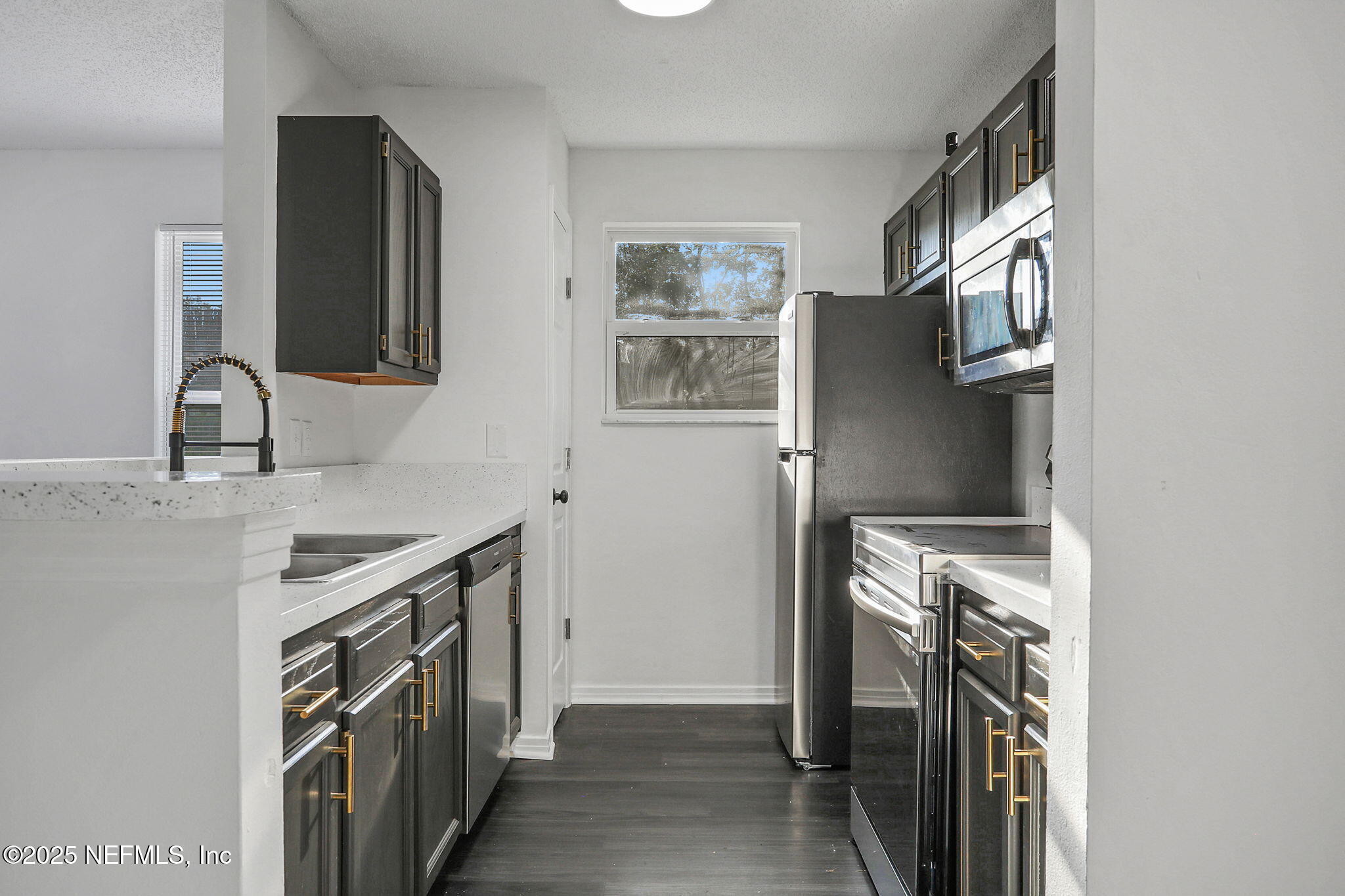 2122 Brooklyn Road Jacksonville, FL 32209 - Photo 5 of 19 a kitchen with a sink stove and refrigerator