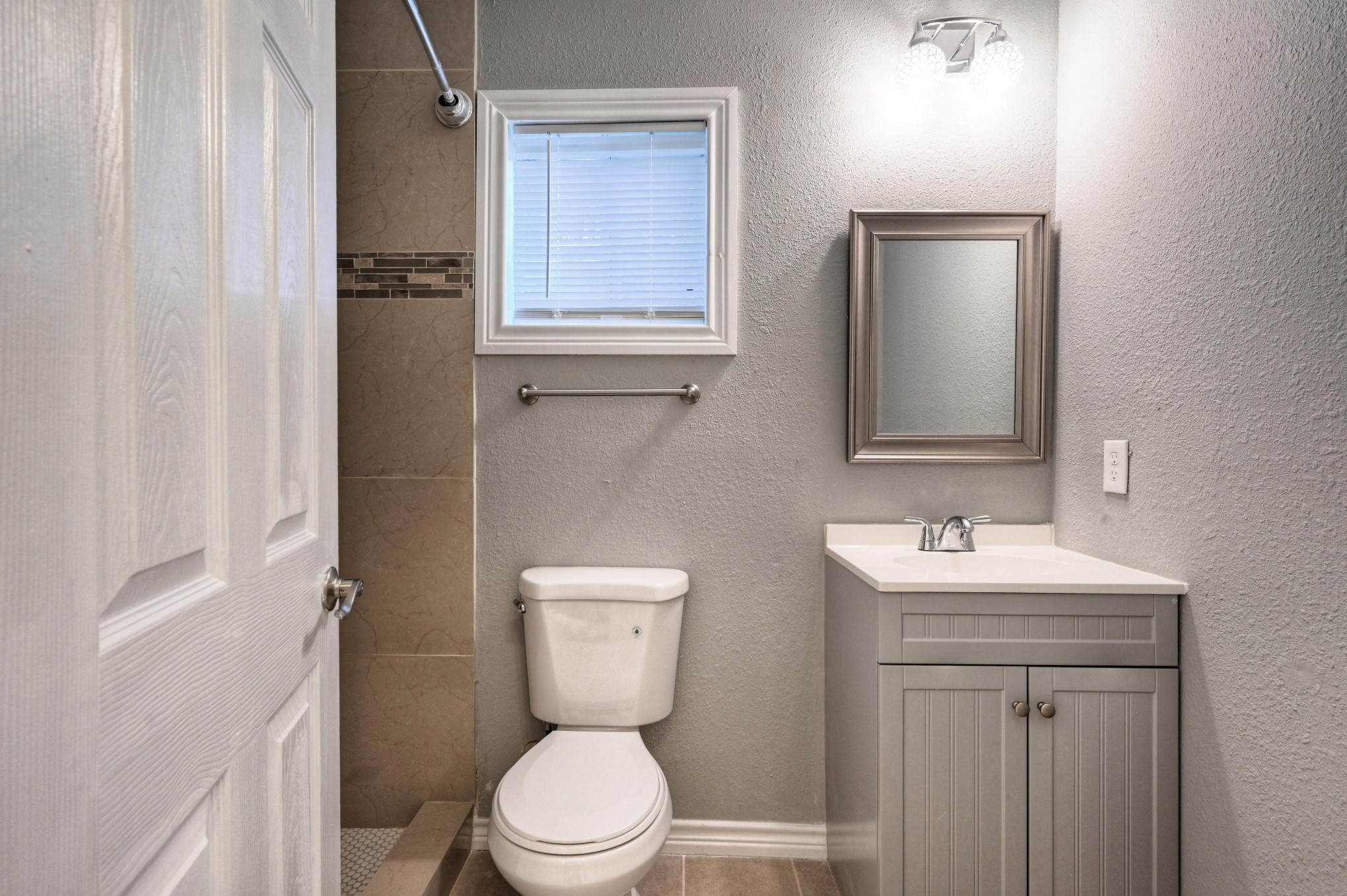 10157 Barberry Street Willis, TX 77318 - Photo 13 of 36 a bathroom with a toilet a sink and mirror