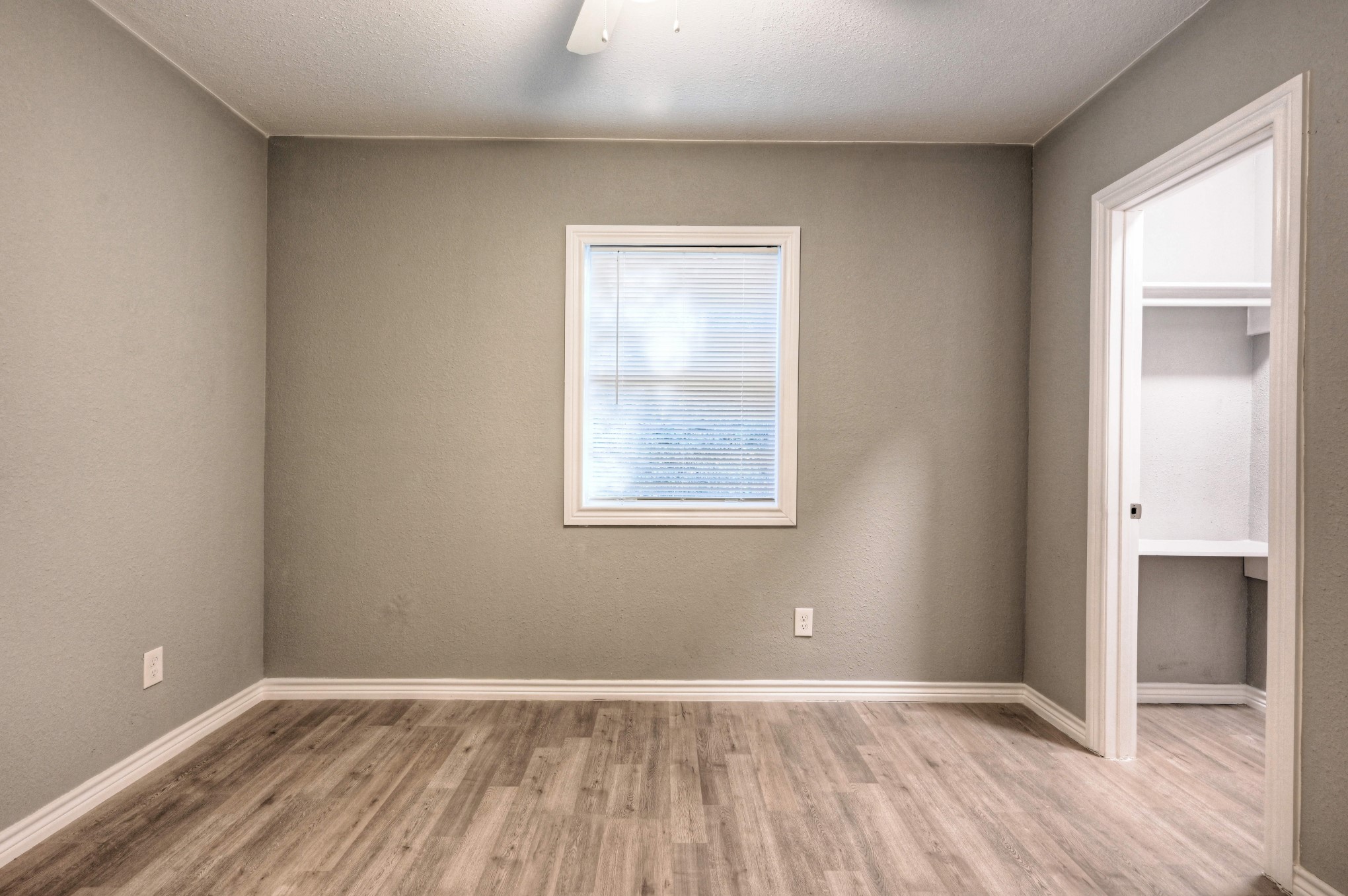 10157 Barberry Street Willis, TX 77318 - Photo 14 of 36 an empty room with wooden floor and a window