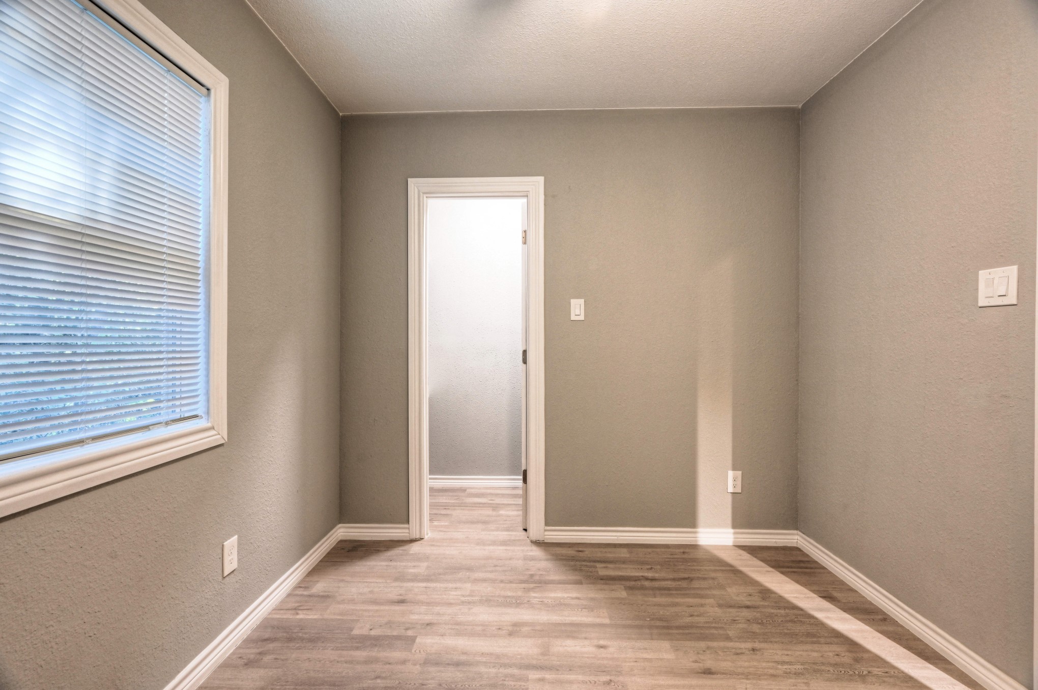 10157 Barberry Street Willis, TX 77318 - Photo 15 of 36 an empty room with wooden floor and windows