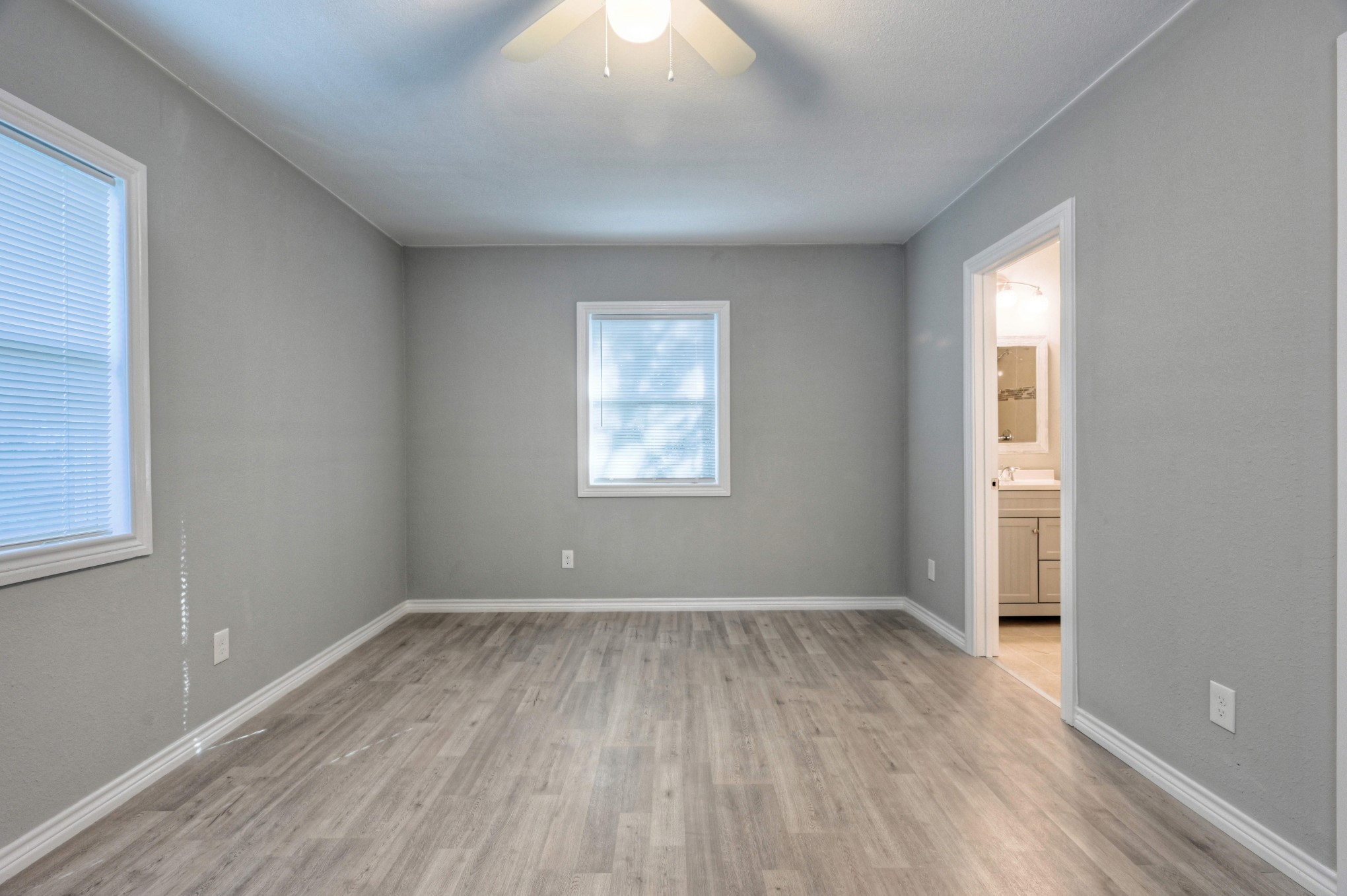 10157 Barberry Street Willis, TX 77318 - Photo 21 of 36 an empty room with wooden floor and windows