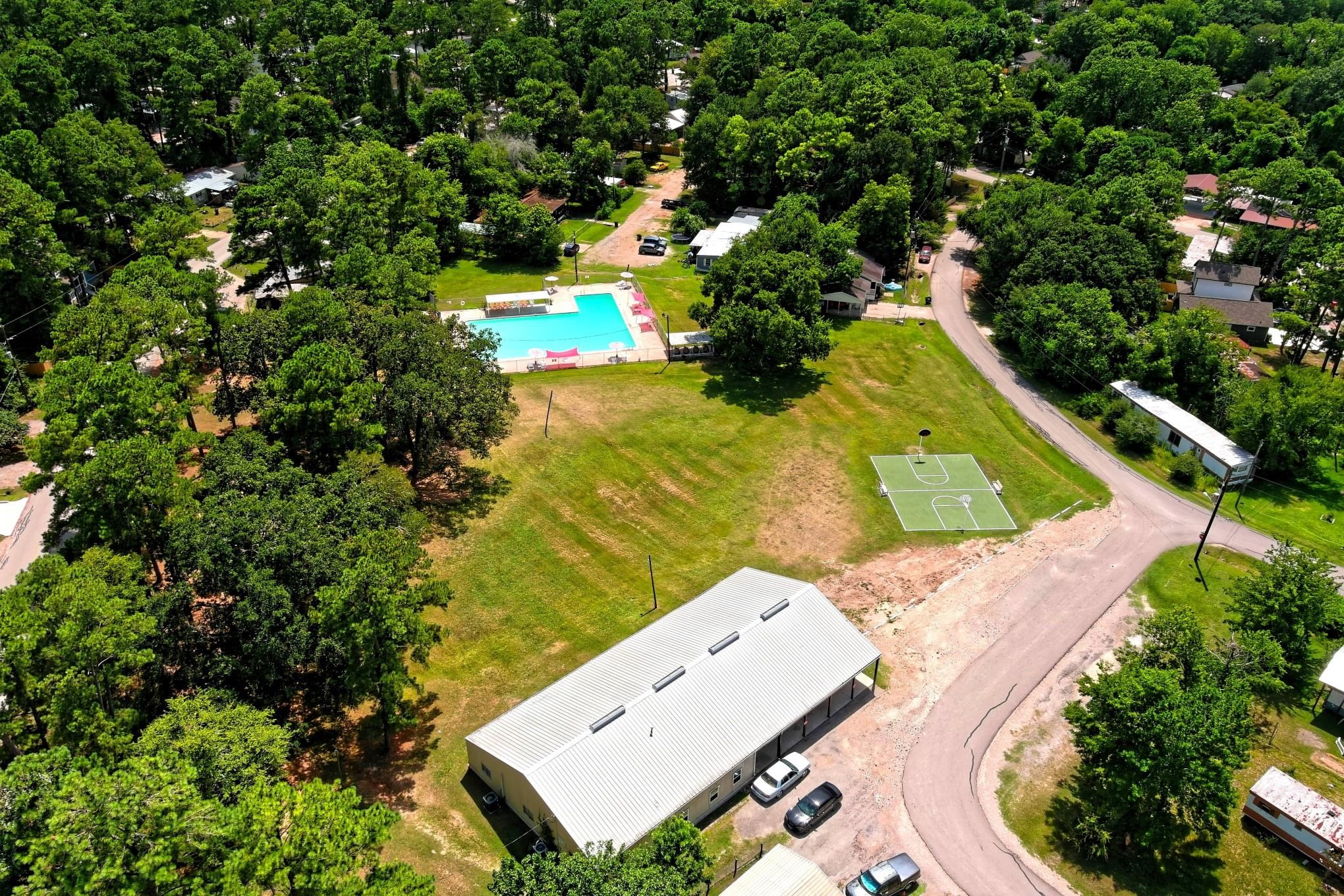 10157 Barberry Street Willis, TX 77318 - Photo 29 of 36 an aerial view of a house with a yard and lake view