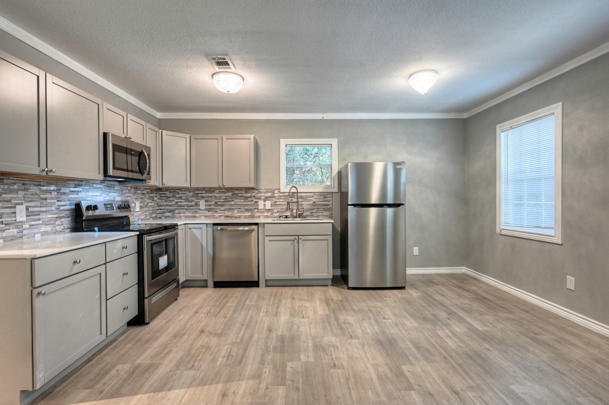 10157 Barberry Street Willis, TX 77318 - Photo 5 of 36 a kitchen with stainless steel appliances granite countertop a refrigerator sink and microwave