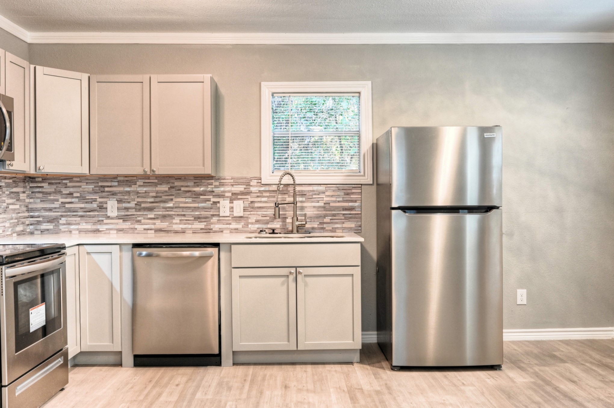 10157 Barberry Street Willis, TX 77318 - Photo 6 of 36 a kitchen with stainless steel appliances granite countertop a refrigerator sink and cabinets