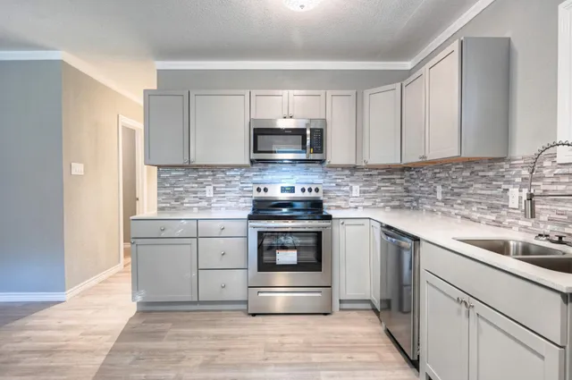 a kitchen with granite countertop a stove and a sink