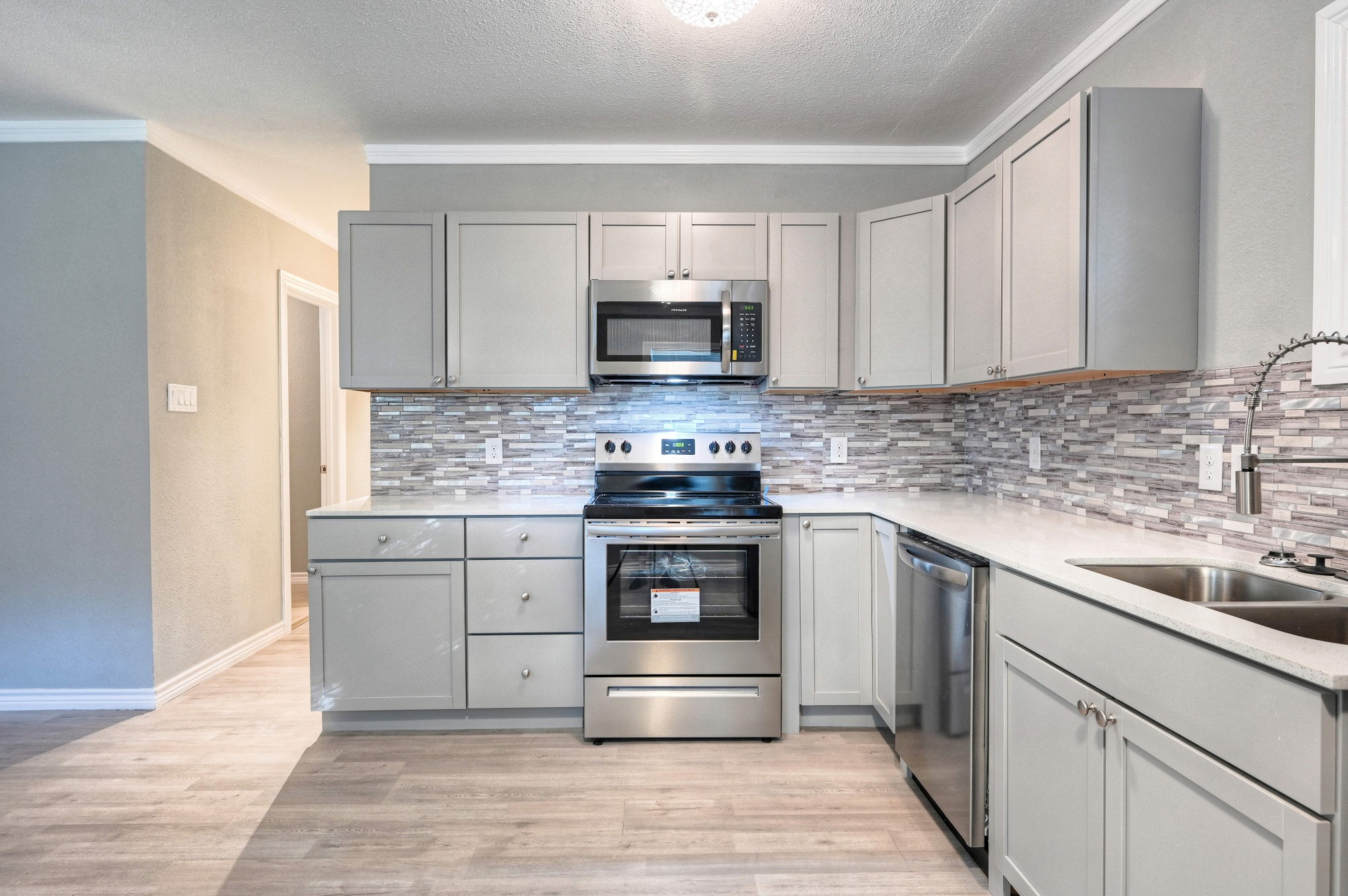 10157 Barberry Street Willis, TX 77318 - Photo 8 of 36 a kitchen with granite countertop a stove and a sink