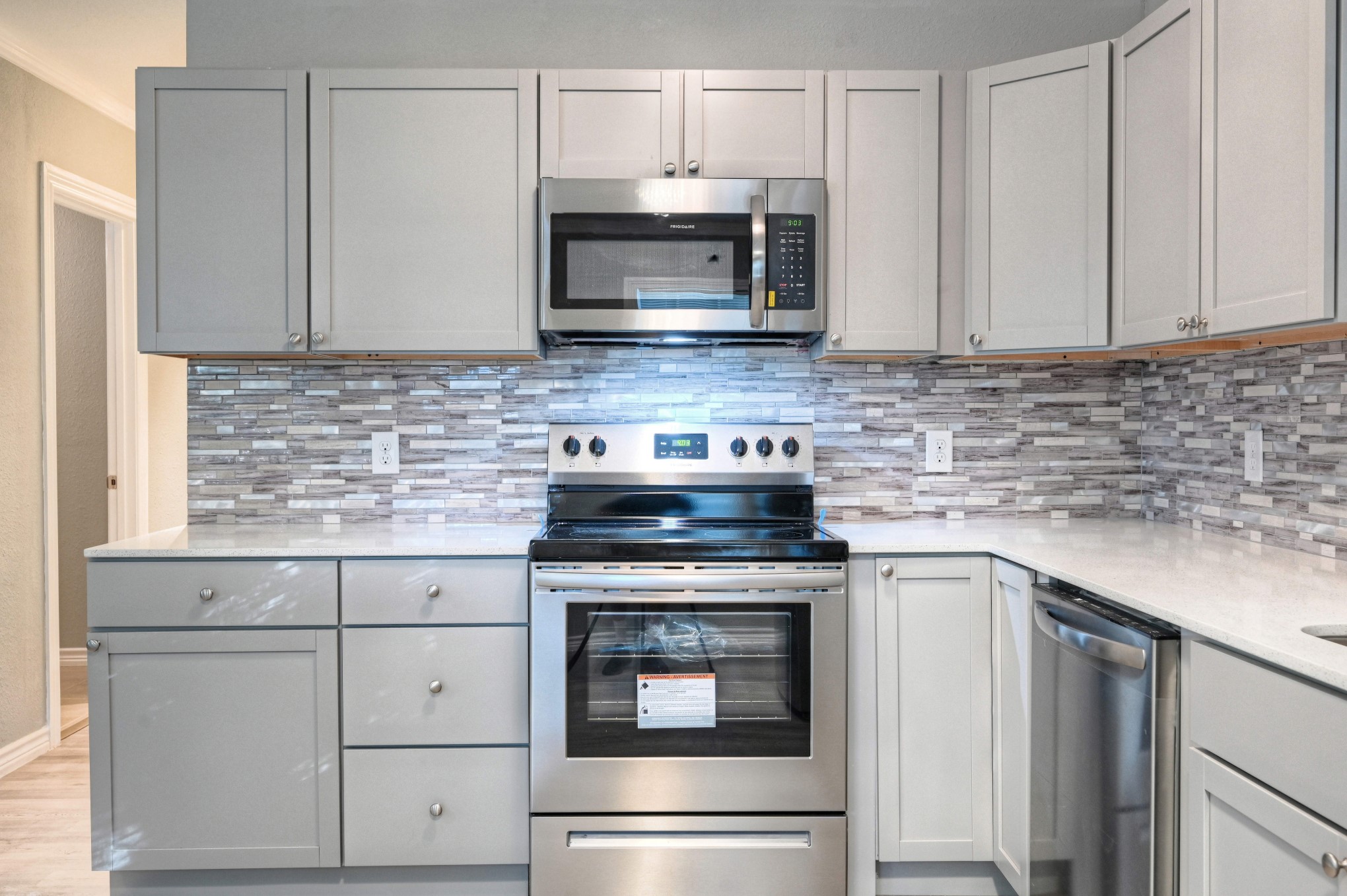 10157 Barberry Street Willis, TX 77318 - Photo 9 of 36 a kitchen with granite countertop white cabinets and stainless steel appliances