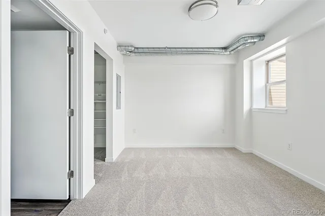 a view of room with window and hardwood floor