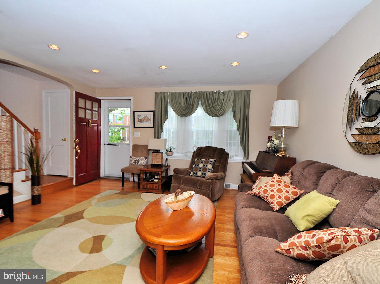 104 Overbrook Road Baltimore, MD 21212 - Photo 4 of 27 a living room with furniture a fireplace and a flat screen tv