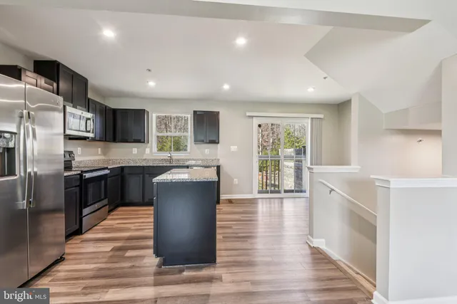 a kitchen with a refrigerator and a sink