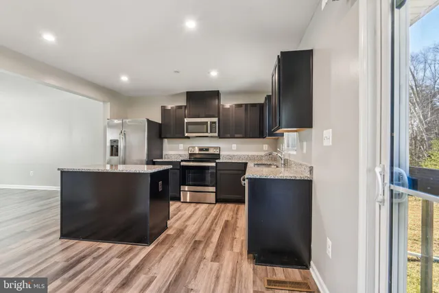 a kitchen with a sink stainless steel appliances and cabinets
