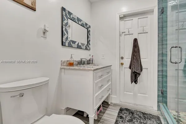 a bathroom with a sink toilet and shower