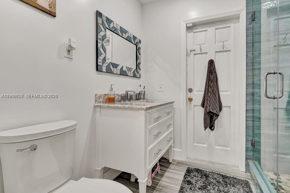 19821 Eagle Nest Road Cutler Bay, FL 33157 - Photo 11 of 23 a bathroom with a sink toilet and shower