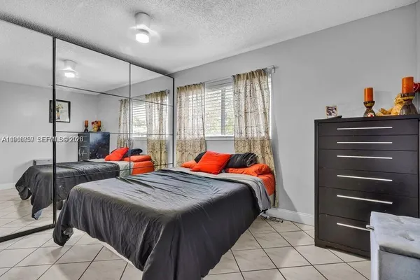 a bedroom with two bed and a closet