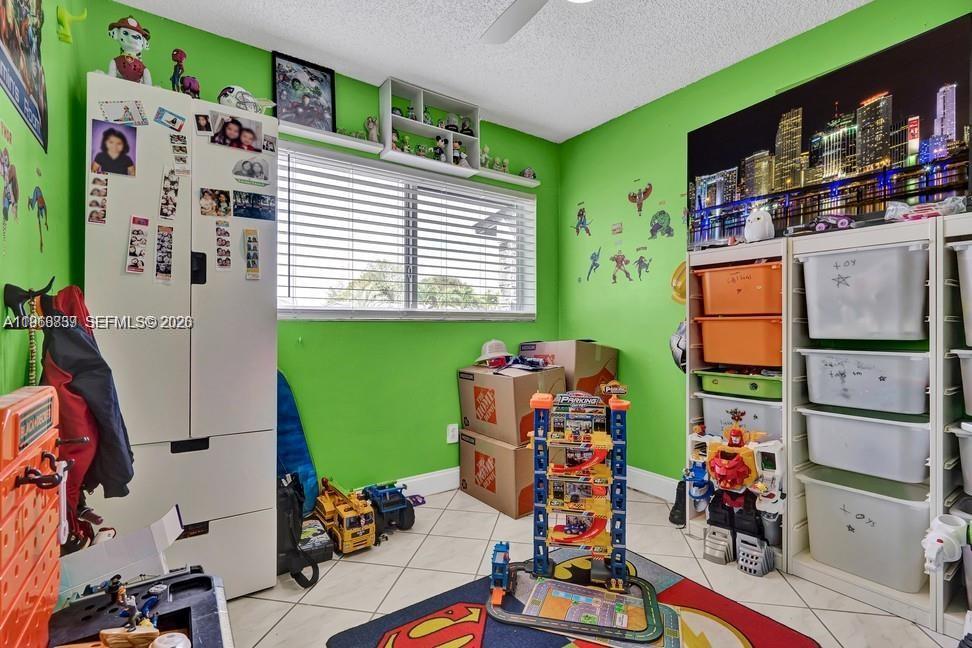 19821 Eagle Nest Road Cutler Bay, FL 33157 - Photo 16 of 23 a room with toys and a flat screen tv