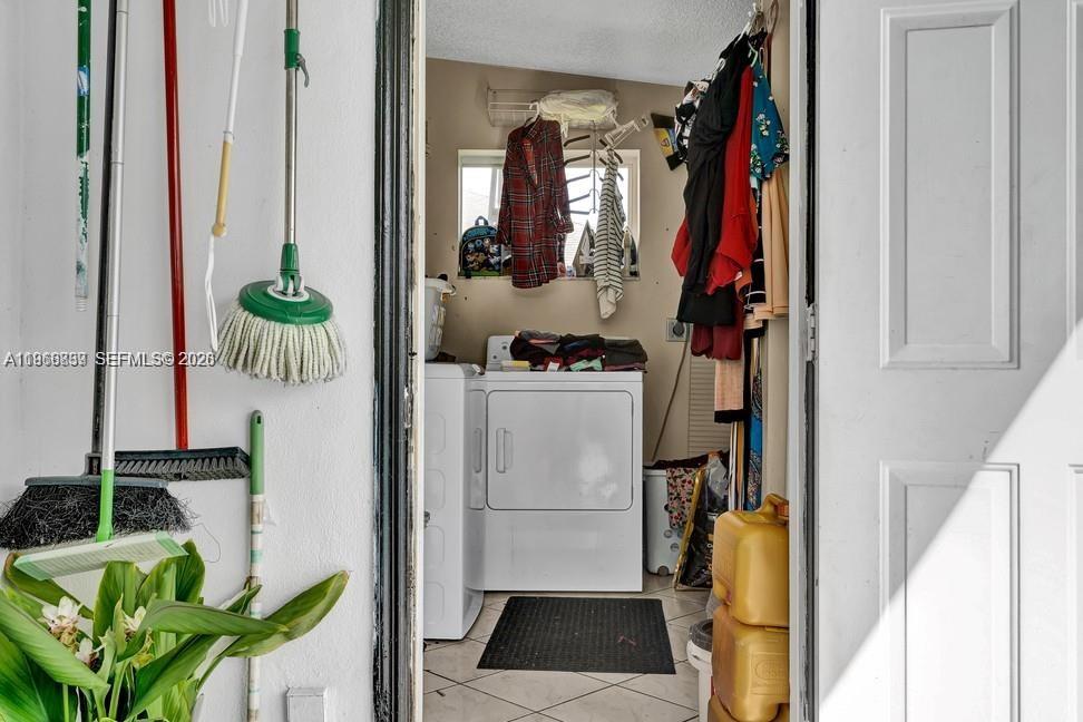 19821 Eagle Nest Road Cutler Bay, FL 33157 - Photo 18 of 23 a view of walk in closet with clothes and shoes