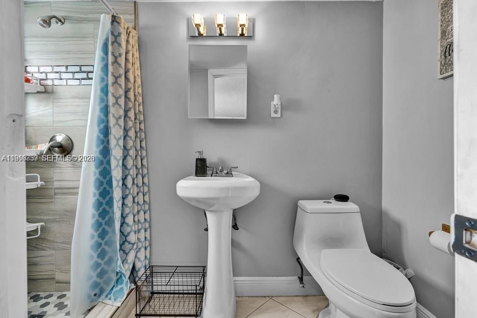 19821 Eagle Nest Road Cutler Bay, FL 33157 - Photo 19 of 23 a bathroom with a toilet sink and shower