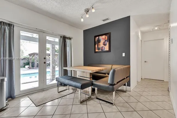 a living room with furniture and a floor to ceiling window