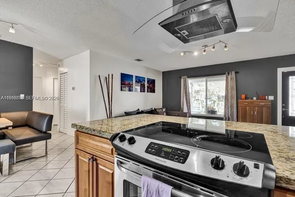 a stove top oven sitting inside of a kitchen