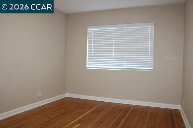 an empty room with wooden floor