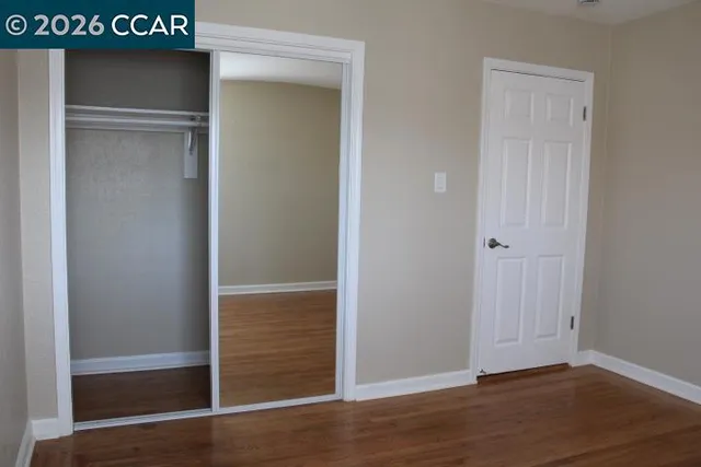 an empty room with wooden floor