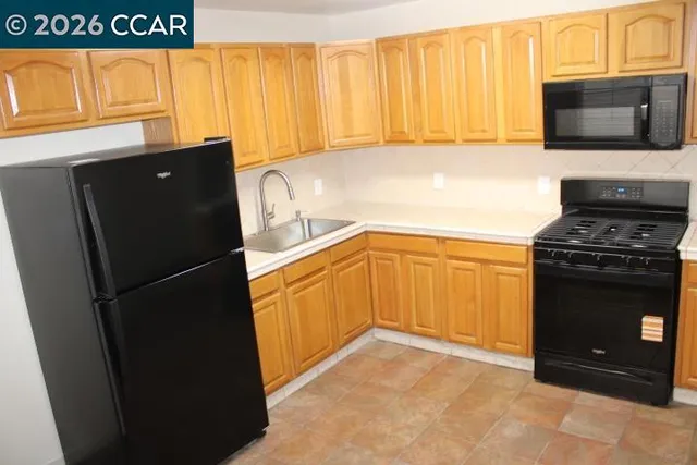 a kitchen with a refrigerator and a stove