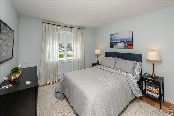 a bedroom with a bed and a lamp on table