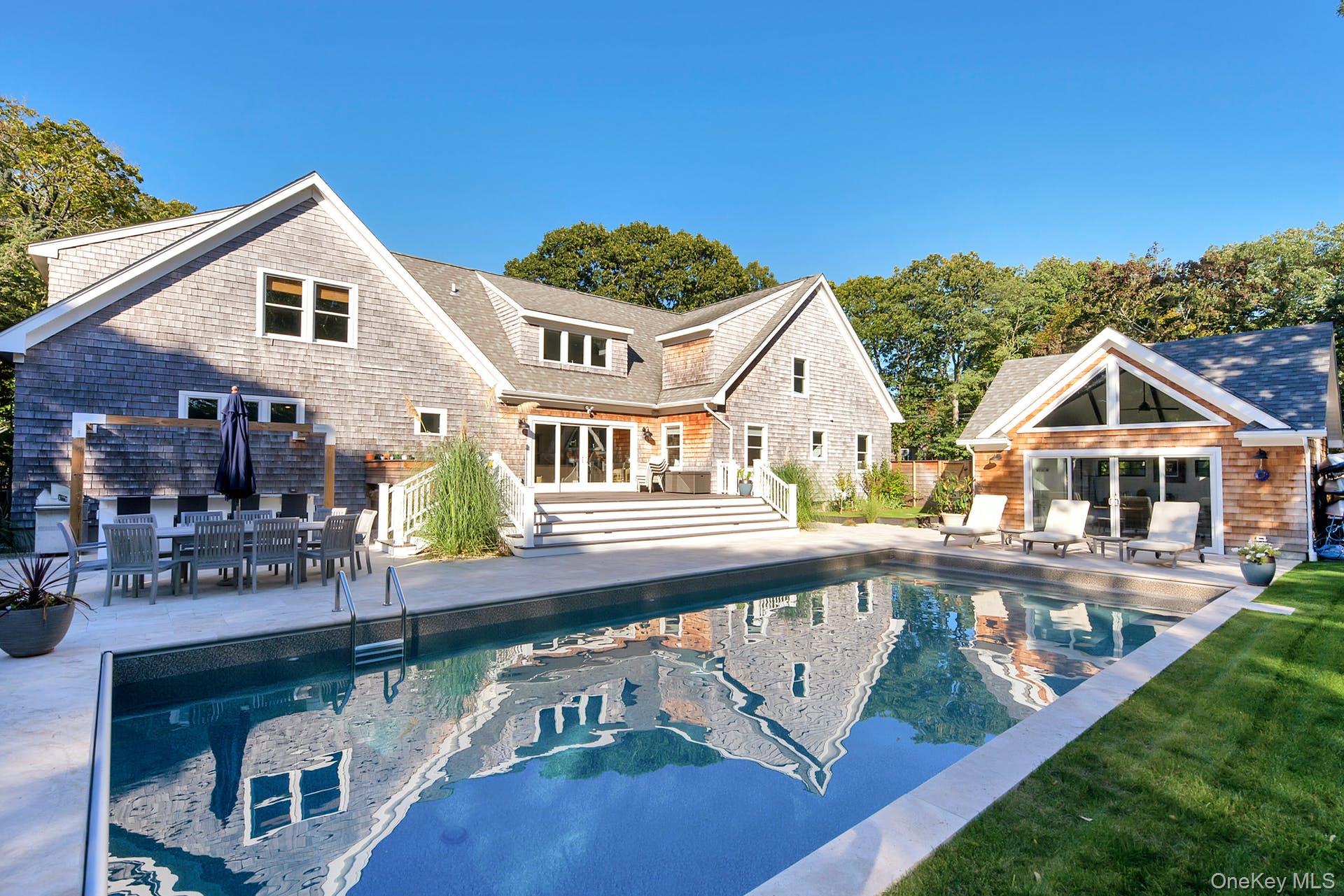 a view of a white house with a yard