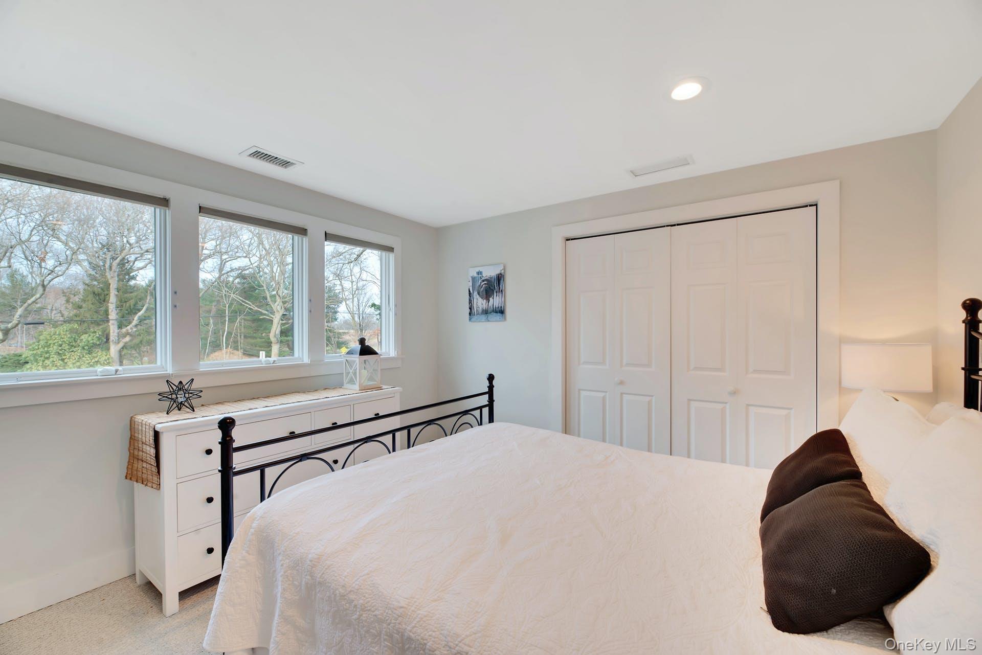 550 Krause Road Mattituck, NY 11952 - Photo 15 of 34 a bedroom with a bed and a large window