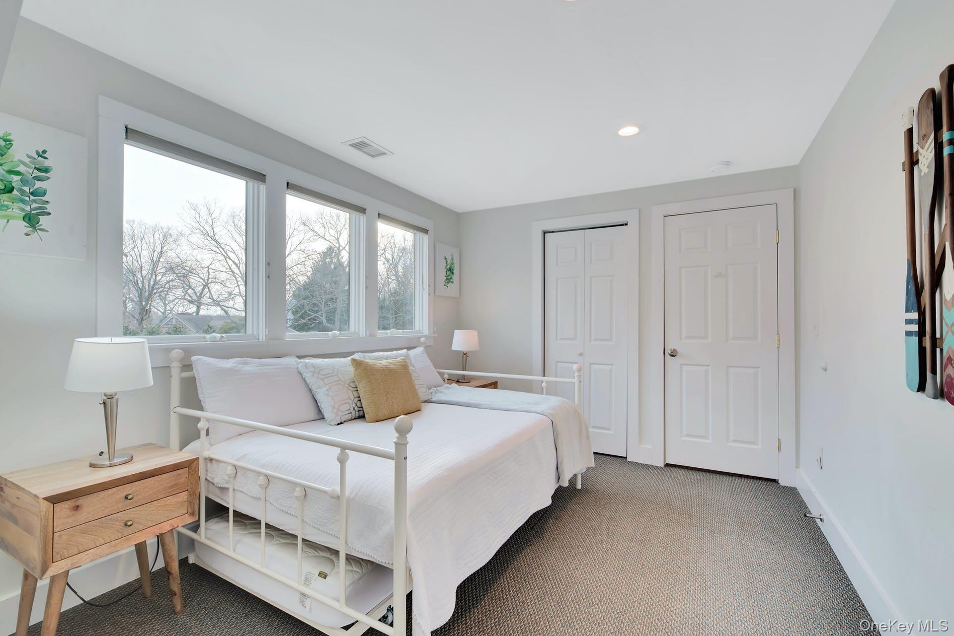 550 Krause Road Mattituck, NY 11952 - Photo 16 of 34 a bedroom with a bed and a window