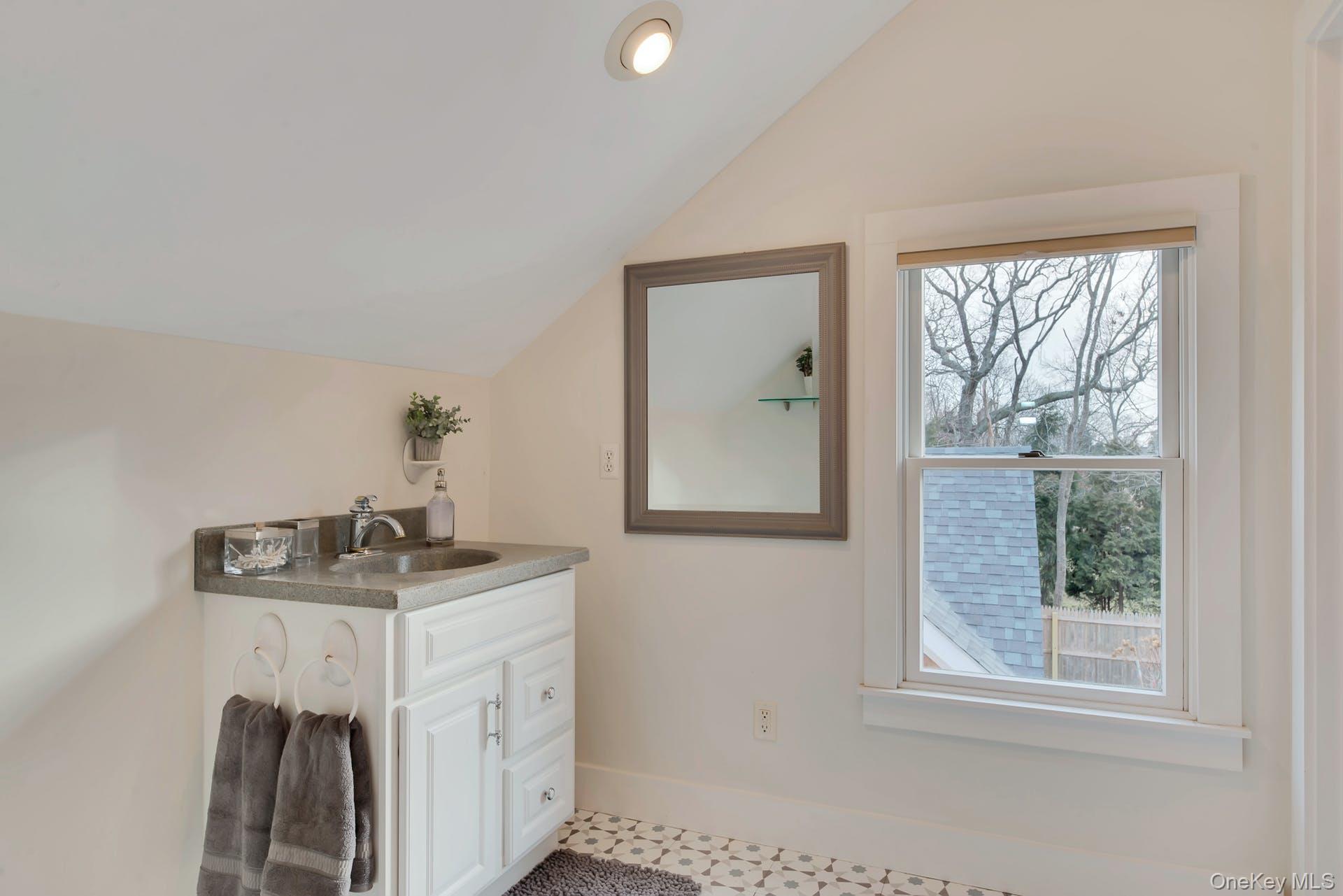 550 Krause Road Mattituck, NY 11952 - Photo 19 of 34 a bathroom with a sink and a mirror