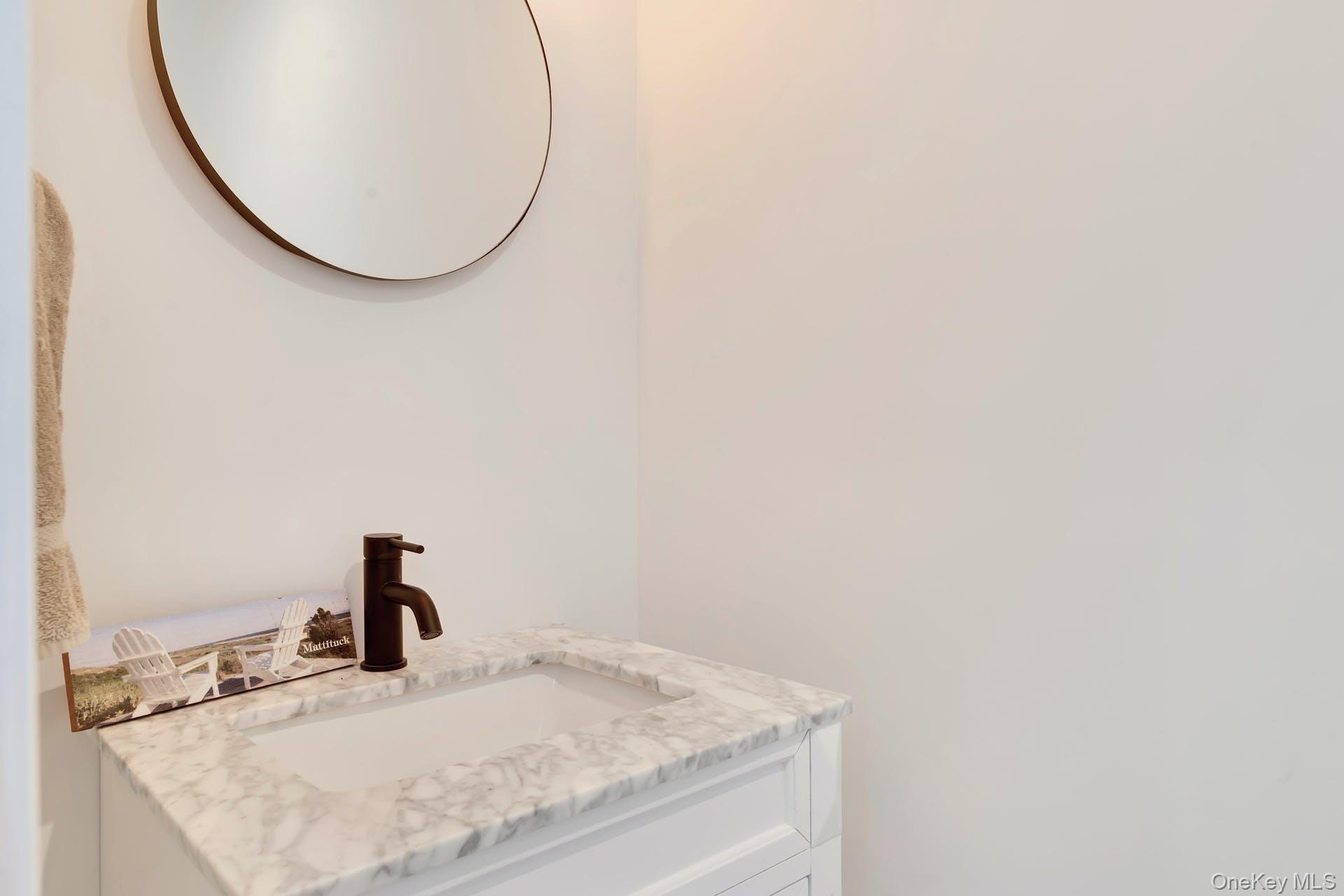 550 Krause Road Mattituck, NY 11952 - Photo 21 of 34 a bathroom with a granite countertop sink and a mirror
