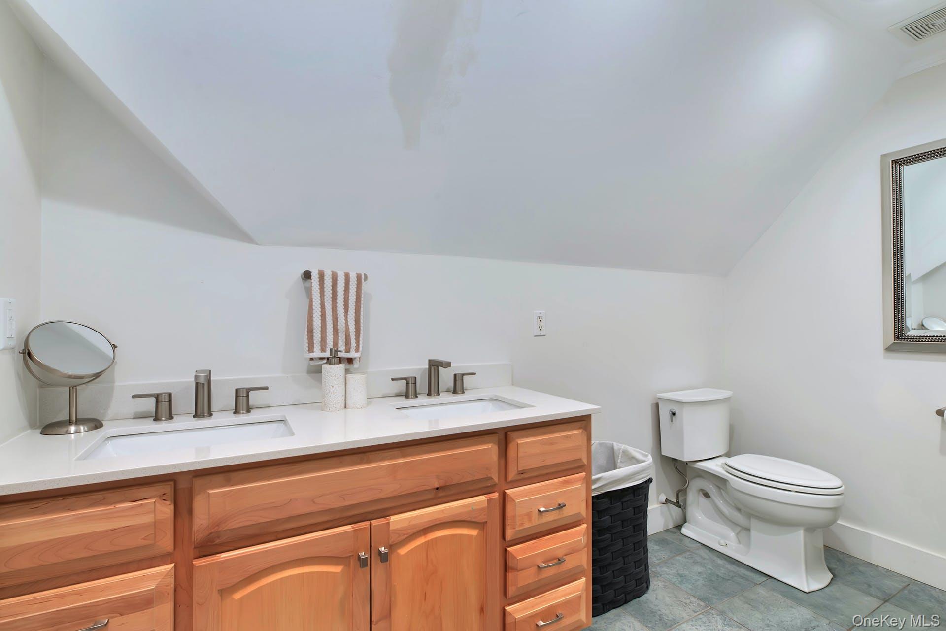 550 Krause Road Mattituck, NY 11952 - Photo 23 of 34 a bathroom with a toilet sink and mirror